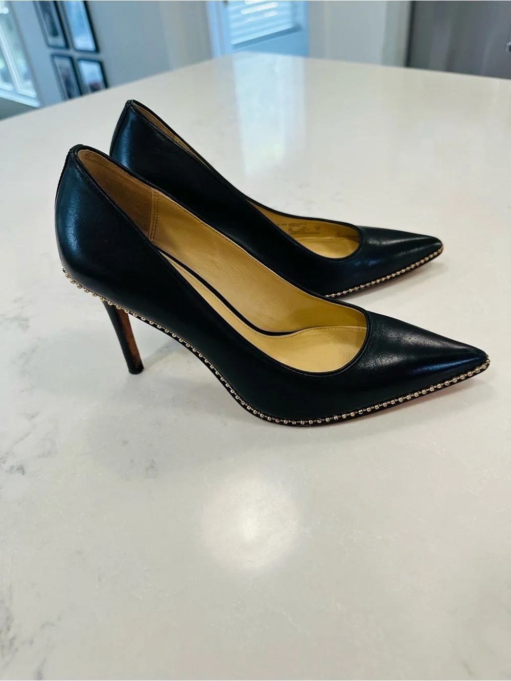 Coach Tamera Black Leather Pointed Toe Pumps with Gold Beaded Accent